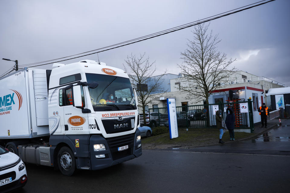 A truck leaves Novasep factory in Seneffe, Belgium, Friday, Jan. 29, 2021. Amid a dispute over expected shortfalls, the European Union is looking at legal ways to guarantee the delivery of all the COVID-19 vaccine doses it bought from AstraZeneca and other drugmakers as regulators are set to consider approving the Anglo-Swedish company's vaccine for use in the 27-nation EU. (AP Photo/Francisco Seco)