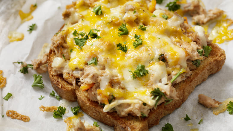 Open-faced tuna melt with cheese and parsley 