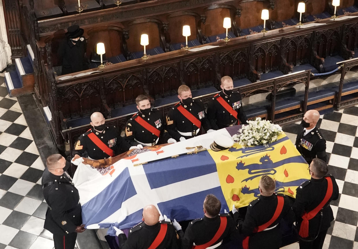 File photo dated 17/04/21 of Queen Elizabeth II watching as the coffin of the Duke of Edinburgh is placed St George's Chapel, Windsor Castle, Berkshire during his funeral service. Issue date: Sunday January 30, 2022.