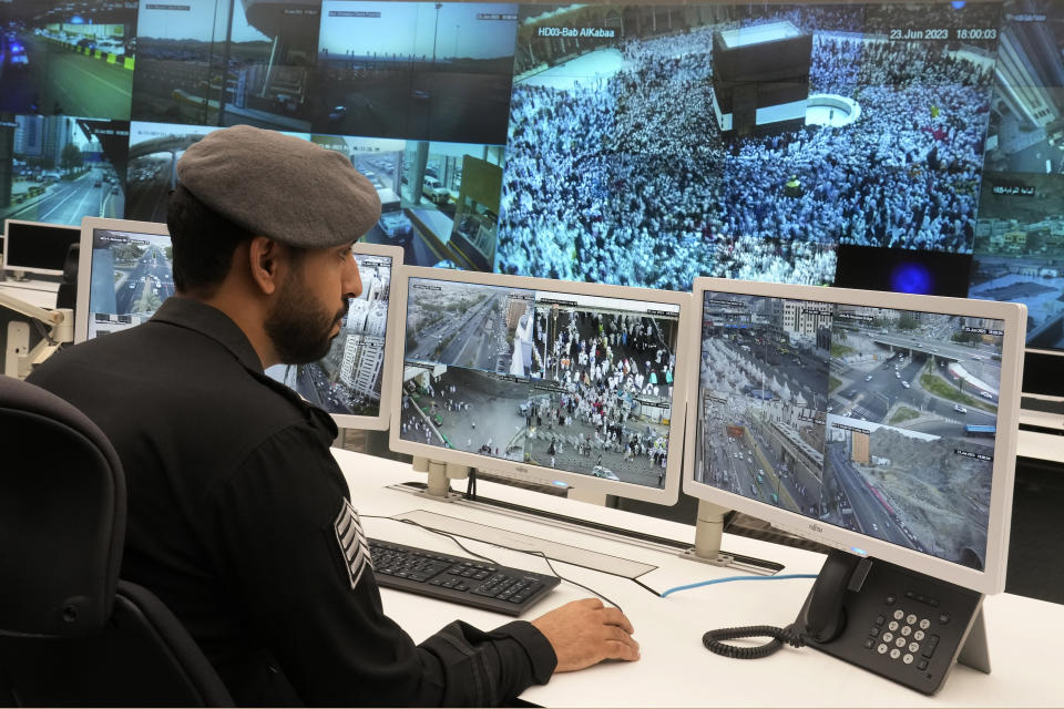 A Saudi police officer monitors screens displaying the Grand Mosque, at the 911 monitoring center, ahead of the Hajj pilgrimage in the Muslim holy city of Mecca, Saudi Arabia, Friday, June 23, 2023. Muslim pilgrims are converging on Saudi Arabia's holy city of Mecca for the largest hajj since the coronavirus pandemic severely curtailed access to one of Islam's five pillars. (AP Photo/Amr Nabil)