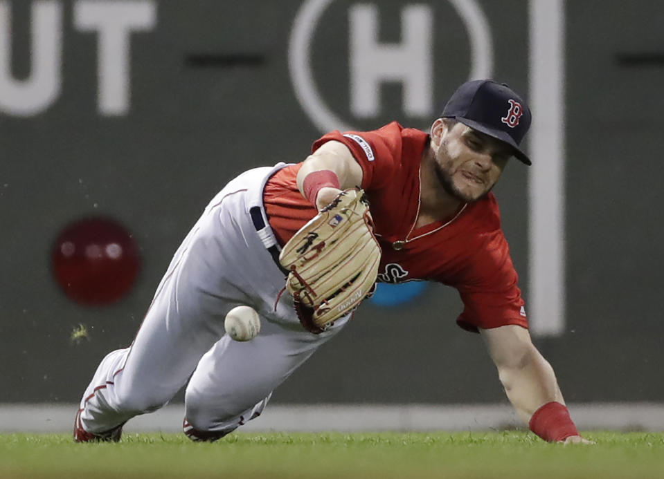 Boston Red Sox left fielder Andrew Benintendi divesfor but can't make the catch on a single by Los Angeles Dodgers' Alex Verdugo during the fifth inning of a baseball game at Fenway Park, Friday, July 12, 2019, in Boston. (AP Photo/Elise Amendola)