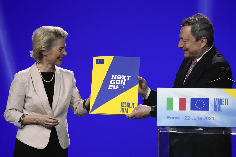 Italian Premier Mario Draghi receives a Next Gen EU plan brochure from European Commission President Ursula von der Leyen, at the Cinecitta' studios in Rome, Tuesday, June 22, 2021. (AP Photo/Andrew Medichini)