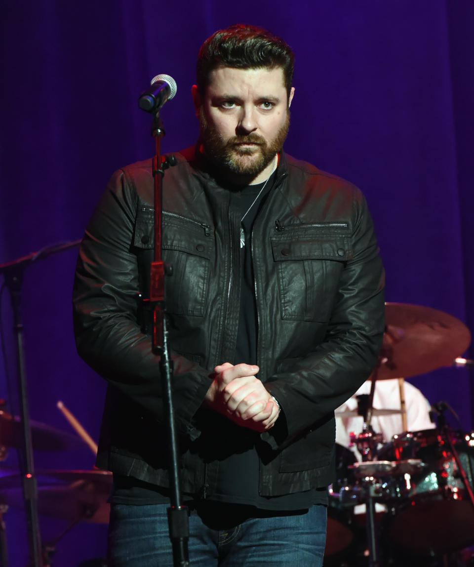 Country singer Chris Young in a leather jacket on stage