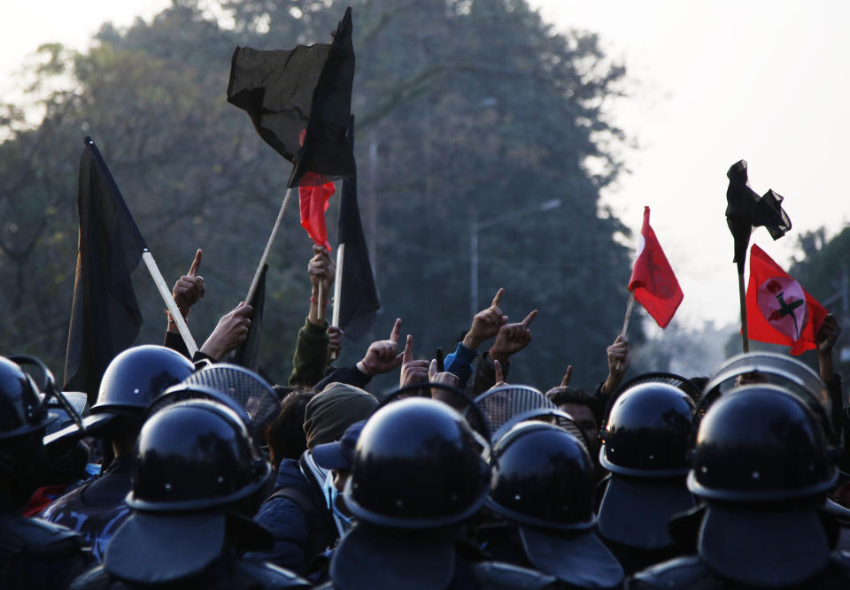 Nepalese students affiliated with Nepal Student Union chant slogans against prime minister Khadga Prasad Oli during a protest in Kathmandu, Nepal, Sunday, Dec. 20, 2020. Nepal’s president dissolved Parliament on Sunday after the prime minister recommended the move amid an escalating feud within his Communist Party that is likely to push the Himalayan nation into a political crisis. Parliamentary elections will be held on April 30 and May 10, according to a statement from President Bidya Devi Bhandari's office. (AP Photo/Niranjan Shrestha)