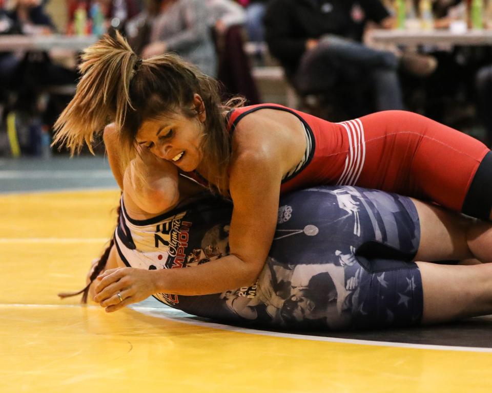 Billie Sims, in red, takes the win over Becca Roper, in blue, 7-0 in the StaleMates II competition Oct. 29, 2021, at the Elwell Family Food Center at the Iowa State Fairgrounds, Des Moines.