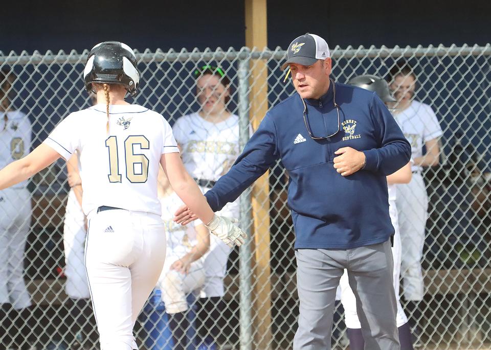 Essex's Chris Baker, right, high-fives his daughter, Maisie Baker, during a 2023 high school softball game. Chris Baker, 46, died unexpectedly from a pre-existing heart condition on April, 2, 2024.