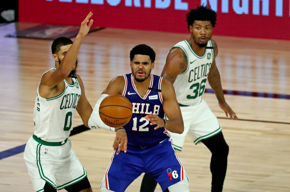 Aug. 21, 2020; Lake Buena Vista, Florida; Philadelphia 76ers forward <a class="link " href="https://sports.yahoo.com/nba/players/4901" data-i13n="sec:content-canvas;subsec:anchor_text;elm:context_link" data-ylk="slk:Tobias Harris;sec:content-canvas;subsec:anchor_text;elm:context_link;itc:0">Tobias Harris</a> (12) passes the ball away from Boston Celtics forward <a class="link " href="https://sports.yahoo.com/nba/players/5765" data-i13n="sec:content-canvas;subsec:anchor_text;elm:context_link" data-ylk="slk:Jayson Tatum;sec:content-canvas;subsec:anchor_text;elm:context_link;itc:0">Jayson Tatum</a> (0) and guard <a class="link " href="https://sports.yahoo.com/nba/players/5317" data-i13n="sec:content-canvas;subsec:anchor_text;elm:context_link" data-ylk="slk:Marcus Smart;sec:content-canvas;subsec:anchor_text;elm:context_link;itc:0">Marcus Smart</a> (36) during the second half in an NBA basketball first-round playoff game at The Field House. Kim Klement-USA TODAY Sports