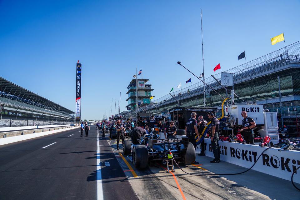 The team of A. J. Foyt Enterprises driver Tatiana Calderon (11) prepares her car Friday, May 13, 2022, prior to the first practice session for the GMR Grand Prix at Indianapolis Motor Speedway.