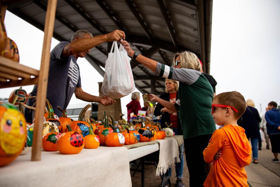 Barb Naber and her grandson, Nicholas Naber, purchase items at the Holland Farmers Market in 2021.