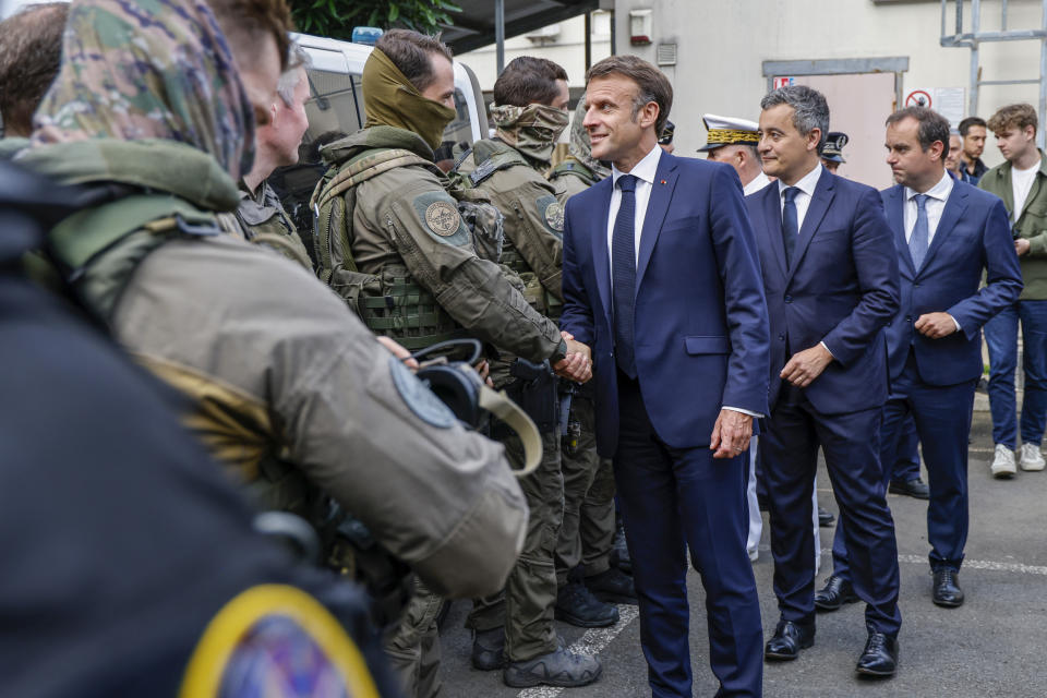 French President Emmanuel Macron visits the central police station in Noumea, New Caledonia, Thursday, May 23, 2024. Macron has met with local officials in riot-hit New Caledonia, after crossing the globe in a high-profile show of support for the French Pacific archipelago gripped by deadly unrest.(Ludovic Marin/Pool Photo via AP)