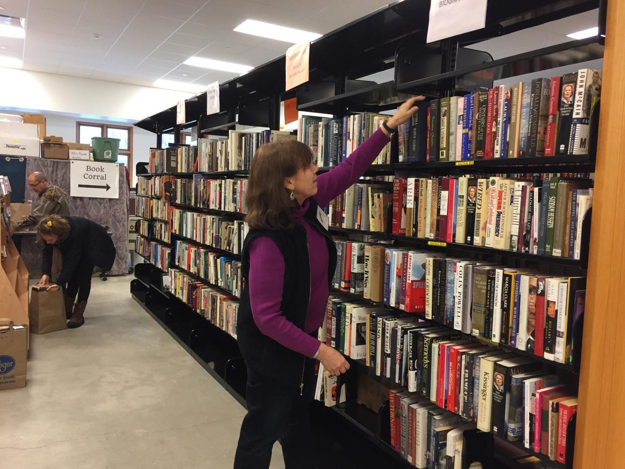 Guest looking at books in library.