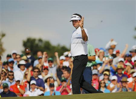 U.S. golfer Bubba Watson reacts after a birdie on the ninth hole during the final round of the Masters golf tournament at the Augusta National Golf Club in Augusta, Georgia April 13, 2014. REUTERS/Brian Snyder