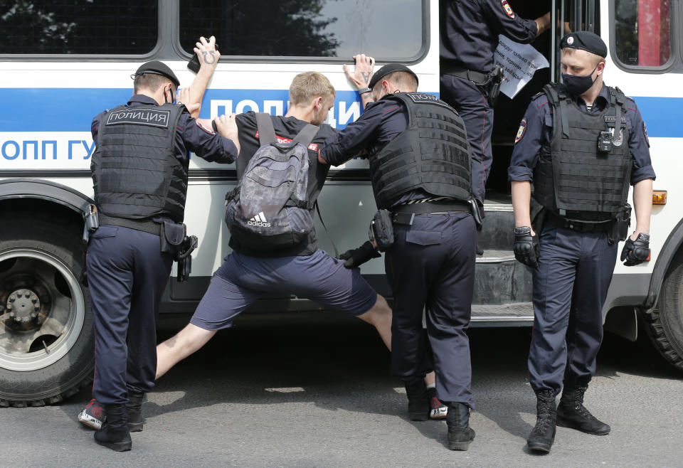 Police officers detain a protester during a rally to support Ivan Safronov near the Lefortovo prison in Moscow, Russia, Monday, July 13, 2020. Safronov, an ex-journalist who worked as an adviser to the director of Russia's state space corporation has been arrested and jailed on charges of passing military secrets to Czech intelligence. Ivan Safronov wrote about military and security issues before becoming an adviser to the head of Roscosmos. (AP Photo/Alexander Zemlianichenko)