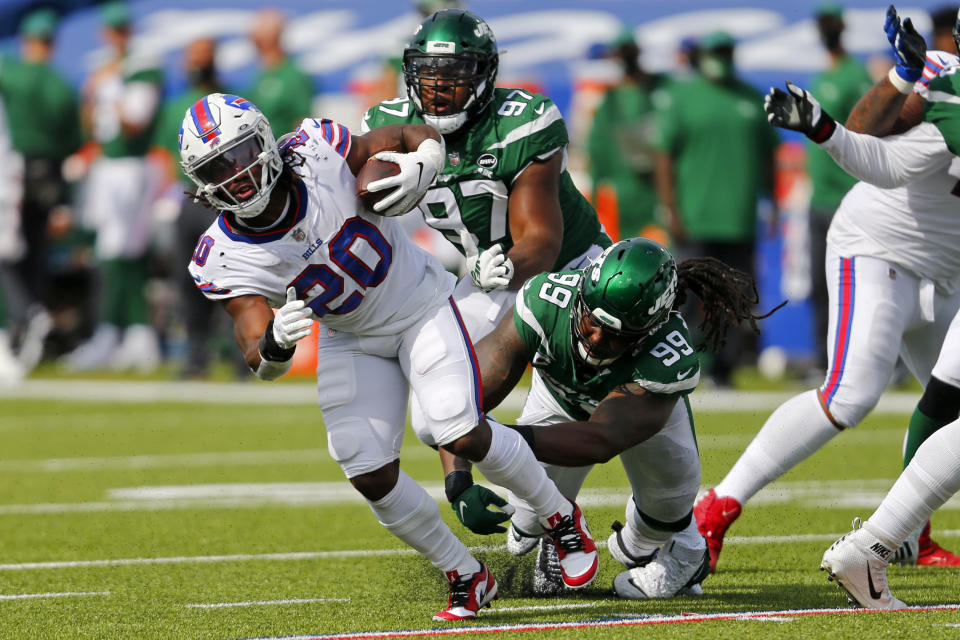 Buffalo Bills running back Zack Moss (20) is tackled by New York Jets nose tackle Steve McLendon (99) during the second half of an NFL football game in Orchard Park, N.Y., Sunday, Sept. 13, 2020. (AP Photo/Jeffrey T. Barnes)