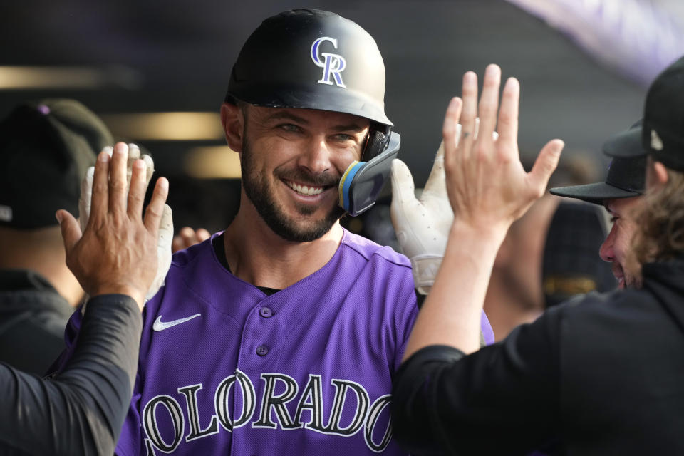 Colorado Rockies' Kris Bryant is congratulated in the dugout for his two-run home run against the Houston Astros during the first inning of a baseball game Tuesday, July 18, 2023, in Denver. (AP Photo/David Zalubowski)