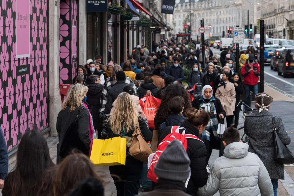 LONDON, UNITED KINGDOM - NOVEMBER 26: Crowds of shoppers walk along Regent Street during the Black Friday discount shopping event in London, United Kingdom on November 26, 2021. British shoppers are expected to spend Ã‚Â£9bn over the coming weekend after last year's slump in sales caused by Covid-19 pandemic. (Photo by Wiktor Szymanowicz/Anadolu Agency via Getty Images)