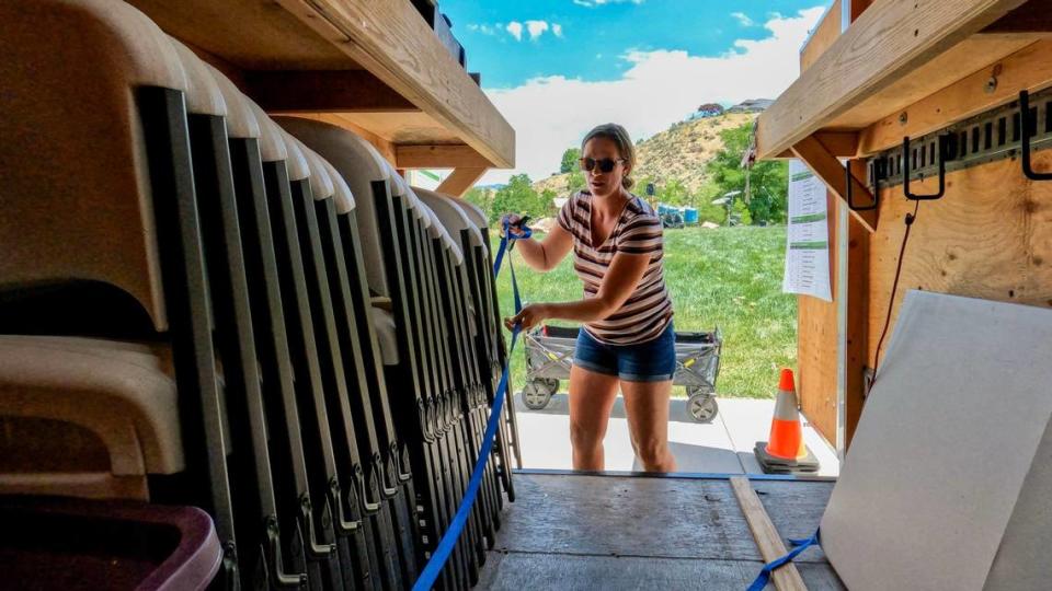 Maggie Benedetti, vice president of the Central Foothills Neighborhood Association, begins pulling chairs and tables out of a trailer provided by the City of Boise for a block party Sunday at Stewart Gulch Park.