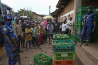 Burundian police officers stand beside crates of avocados in Kayanza province, Burundi, Sept. 18, 2024. (AP Photo/Brian Inganga)