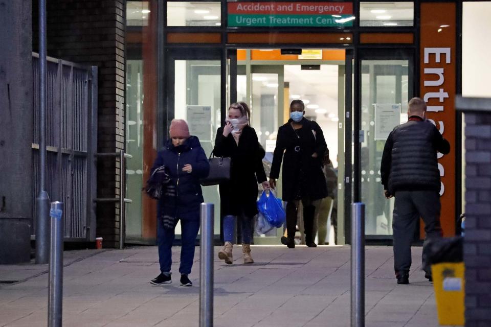 People wearing face masks leave Northwick Park Hospital (AFP via Getty Images)