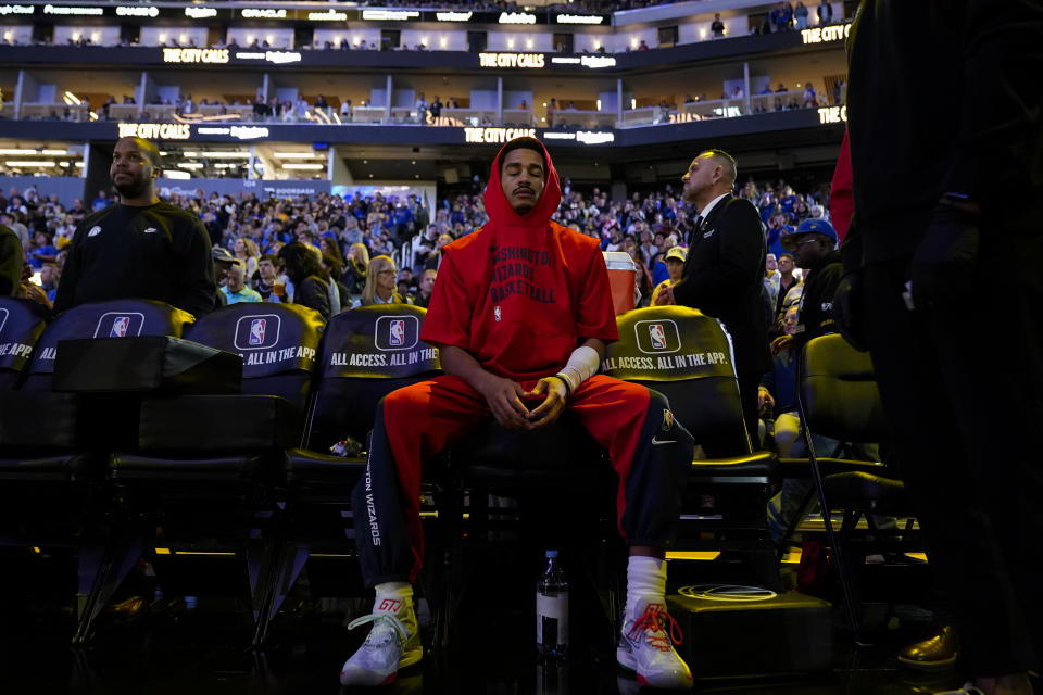 Washington Wizards guard Jordan Poole sits on the bench before the team's NBA basketball game against the Golden State Warriors on Friday, Dec. 22, 2023, in San Francisco. (AP Photo/Godofredo A. Vásquez)