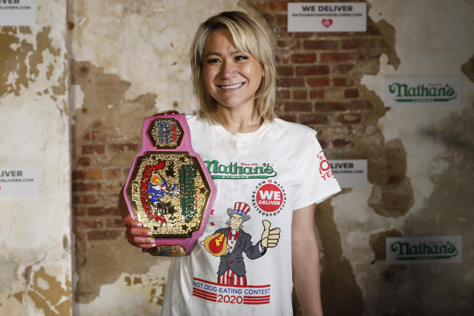 Competitive eater Miki Sudo celebrates after setting the women's world record of 48 and a half hot dogs to win the women's division of the Nathan's Famous July Fourth hot dog eating contest, Saturday, July 4, 2020, in the Brooklyn borough of New York. (AP Photo/John Minchillo)