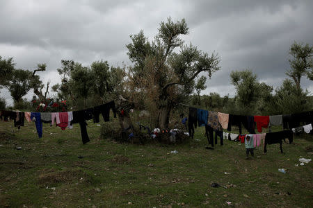 Clothes hang to dry at a makeshift camp for refugees and migrants next to the Moria camp on the island of Lesbos, Greece, December 1, 2017. REUTERS/Alkis Konstantinidis