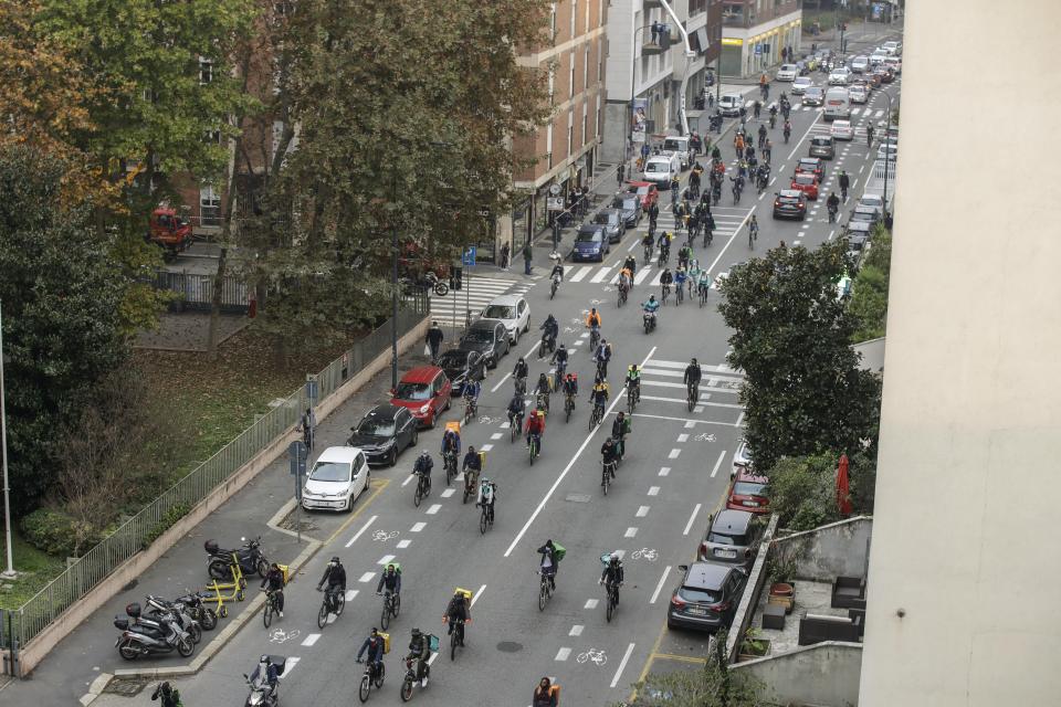 Food delivery riders stage a protest against the government restriction measures to curb the spread of coronavirus in Milan, Italy, Thursday, Nov. 5, 2020. Four regions in Italy are being put under severe lockdown, forbidding people to leave their homes except for essential reasons such as food shopping and work in a bid to slow surging COVID-19 infections and prevent hospitals from being overwhelmed. Premier Giuseppe Conte on Wednesday night announced what he described as “very stringent” restrictions on the so-called “red zone” regions of high risk: Lombardy, Piedmont, Valle d’Aosta in the north and Calabria in the south of the Italian peninsula. (AP Photo/Luca Bruno)