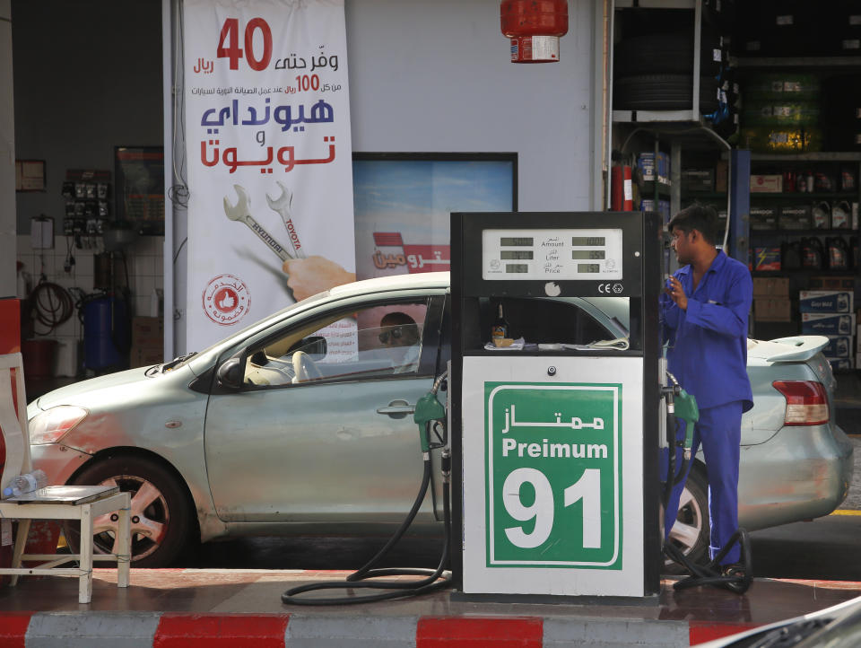 A worker refuels a car at a gas station in Jiddah, Saudi Arabia, Monday, Sept. 16, 2019. Global energy prices spiked on Monday after a weekend attack on key oil facilities in Saudi Arabia caused the worst disruption to world supplies on record, an assault for which President Donald Trump warned that the U.S. was "locked and loaded" to respond. (AP Photo/Amr Nabil)