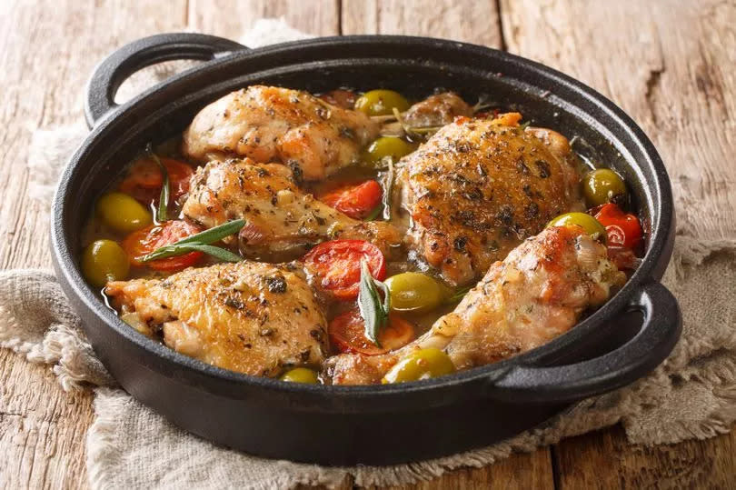 Homemade French chicken baked with green olives, tomatoes and onions.