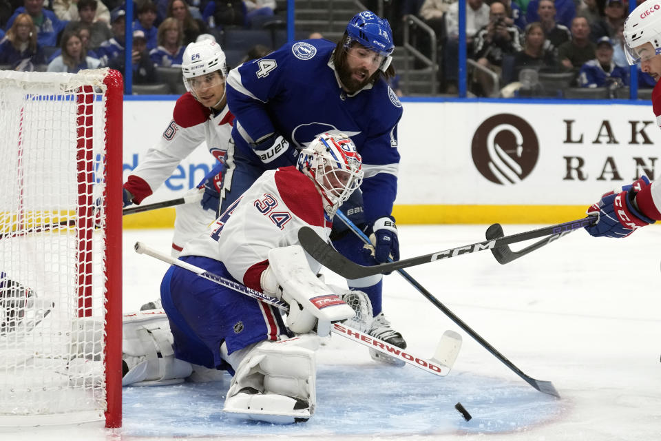 Montreal Canadiens goaltender Jake Allen (34) stops a shot by Tampa Bay Lightning left wing Pat Maroon (14) during the second period of an NHL hockey game Wednesday, Dec. 28, 2022, in Tampa, Fla. (AP Photo/Chris O'Meara)