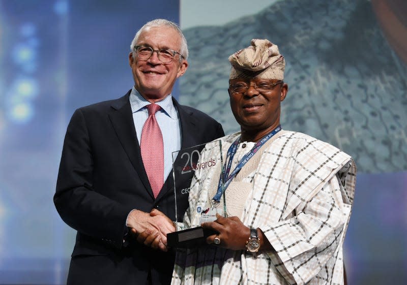 Oba Otudeko (R) founder of Honeywell Group receives the CEO of the Year award from Jay Ireland (L) CEO of General Electric Africa during the Africa CEO Forum Awards