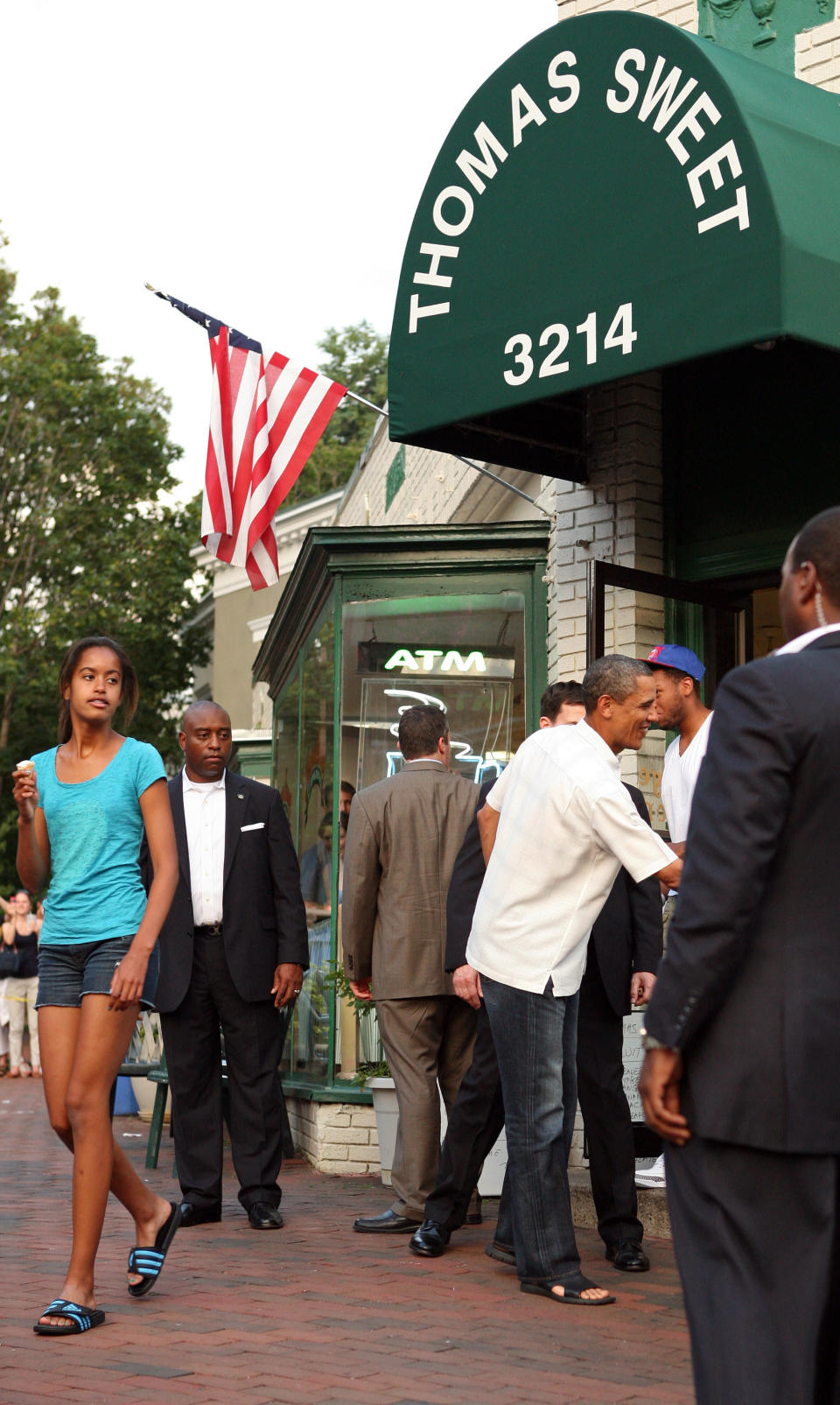 WASHINGTON, DC - JUNE 19:  U.S. President Barack Obama reaches to shake hands with bystanders outside Thomas Sweet ice cream parlour, while out with his daughter, Malia on June 19, 2011 in the Georgetown neighborhood of Washington, D.C. (Photo by Martin H. Simon-Pool/Getty Images)