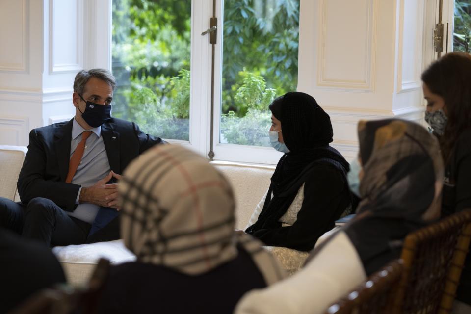 Afghan women attend a meeting with Greece's Prime Minister Kyriakos Mitsotakis at Maximos Mansion, in Athens, Friday, Oct. 15, 2021. The Afghan women, part of a group of judges, lawyers and lawmakers who fled Afghanistan following the Taliban takeover, meet with the Greek Prime Minister before they reach their final destination in the United States. (AP Photo/Petros Giannakouris)