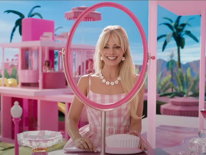 barbie looks into her dream house mirror in a scene from barbie