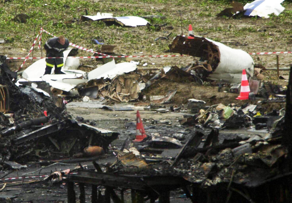 A crash investigator looks amongst the wreckage of the remains of the Concorde aircraft which crashed in Gonesse, near Paris, killing more than 100 people (PA).