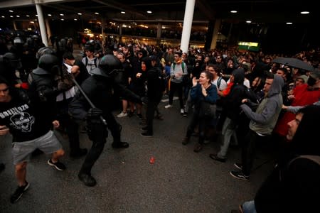 Protesters clash with police officers as they demonstrate at the airport, after a verdict in a trial over a banned independence referendum, in Barcelona