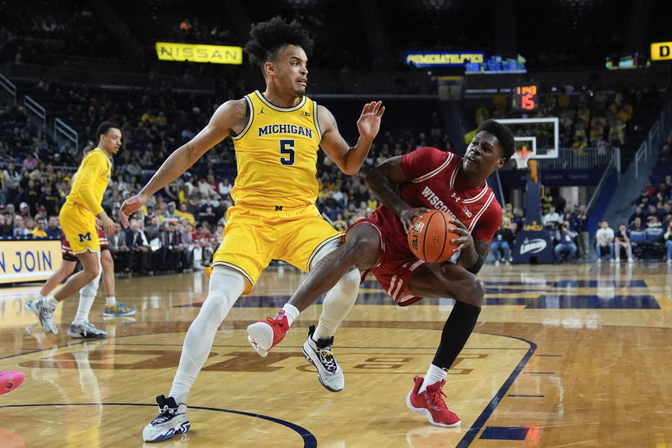 Wisconsin guard AJ Storr (2) drives on Michigan Wolverines forward Terrance Williams II (5) in the first half of an NCAA college basketball game in Ann Arbor, Mich., Wednesday, Feb. 7, 2024. (AP Photo/Paul Sancya)