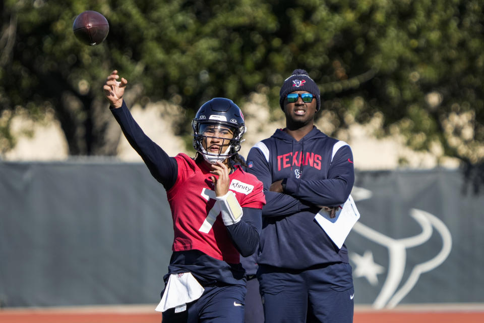 Houston Texans quarterback C.J. Stroud (7) throws a pass as quarterbacks coach Jerrod Johnson looks on during practice on Wednesday, Dec. 27, 2023, at Houston Methodist Training Center in Houston, as the Texans prepare for their matchup against the Tennessee Titans.(Brett Coomer/Houston Chronicle via AP)