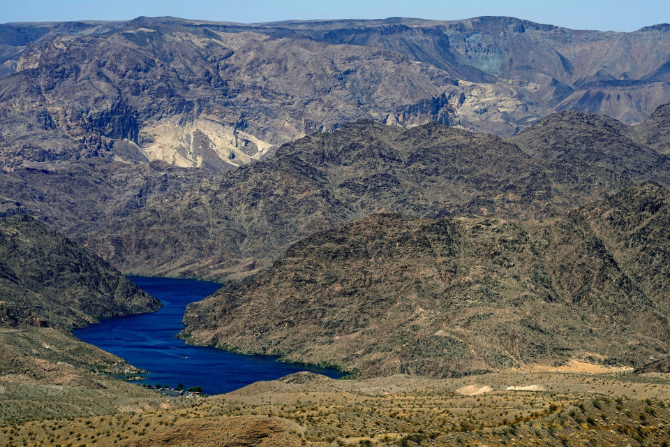 FILE - The Colorado River cuts through Black Canyon, June 6, 2023, near White Hills, Ariz. The seven U.S. states that draw water from the Colorado River basin are suggesting new ways to determine how the increasingly scarce resource is divvied up when the river can't provide what it historically promised. (AP Photo/Matt York, File)