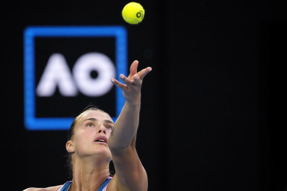 FILE - Aryna Sabalenka of Belarus serves to Elena Rybakina of Kazakhstan in the women's singles final at the Australian Open tennis championship in Melbourne, Australia, Saturday, Jan. 28, 2023. The 2024 Australian Open, the year's first Grand Slam tennis tournament, begins at Melbourne Park on Sunday morning (Saturday night ET). That's a day earlier than usual, creating a 15-day event for the first time.(AP Photo/Dita Alangkara, File)