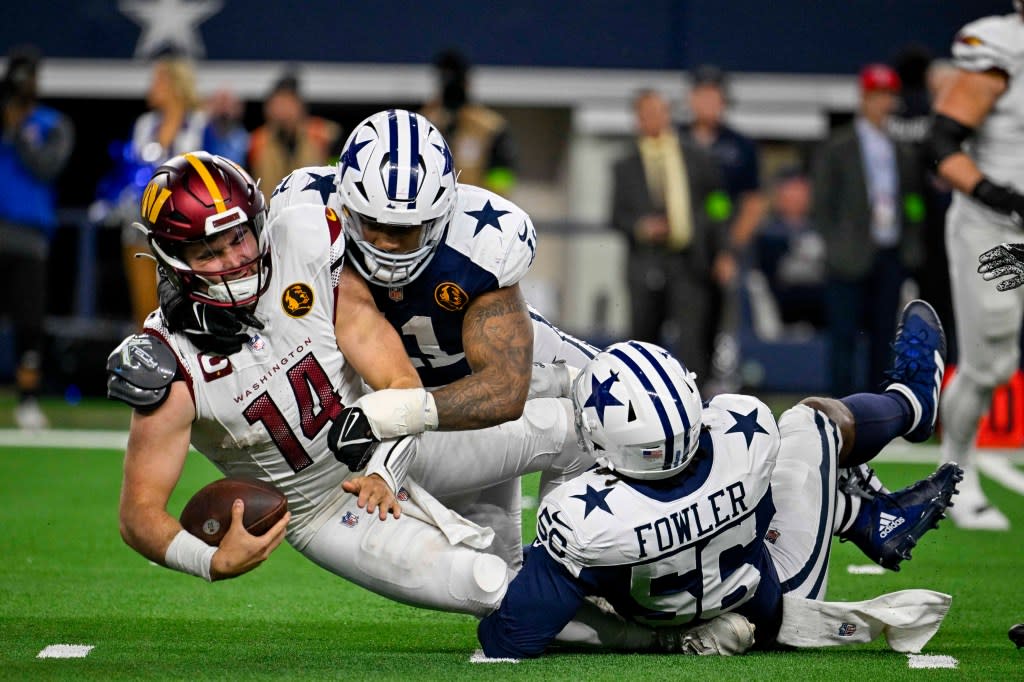 Nov 23, 2023; Arlington, Texas, USA; Dallas Cowboys linebacker Micah Parsons (11) and defensive end Dante Fowler Jr. (56) sack Washington Commanders quarterback Sam Howell (14) during the second half at AT&T Stadium. (Credit: Jerome Miron-USA TODAY Sports)