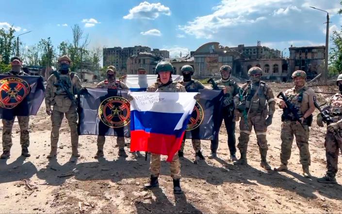 Yevgeny Prigozhin, the head of the Wagner Group military company speaks holding a Russian national flag in front of his soldiers in Bakhmut