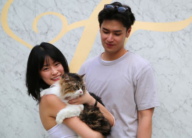 Caesar Yance (right) and cat mother Cheryl Goer bring Goer’s cat, Pixie, a Norwegian forest cat, to the Fête du Feline grand tasting on Monday.