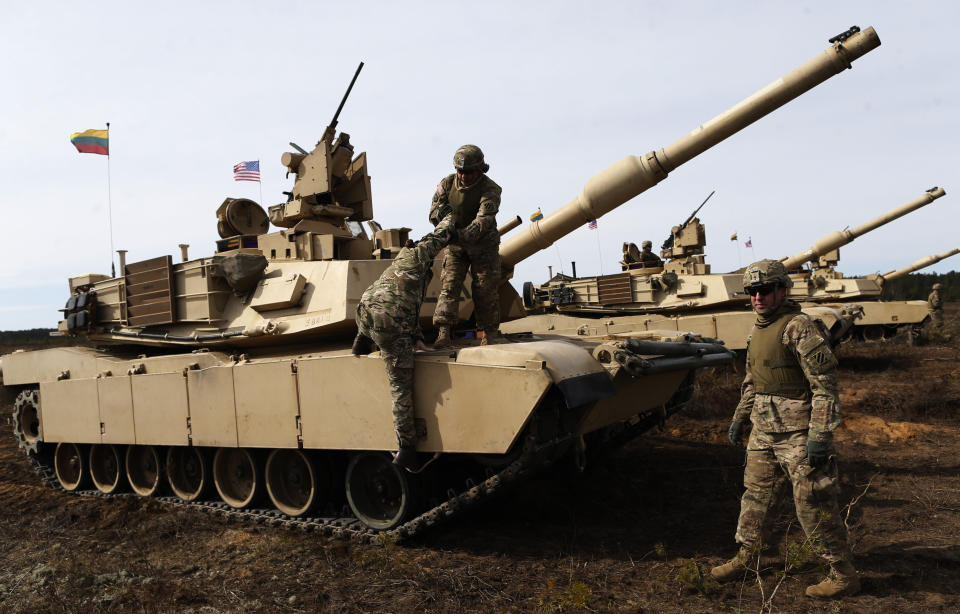 U.S. soldiers from the 2nd Battalion, 1st Brigade Combat Team, 3rd Infantry Division at the M1A2 Abrams battle tank during a military exercise at the Gaiziunu Training Range in Pabrade some 60km.(38 miles) north of the capital Vilnius, Lithuania, Thursday, April 9, 2015. The U.S has been maintaining a persistent presence of rotating land forces on the ground in the Baltic States and Poland since April 2014. (AP Photo/Mindaugas Kulbis)