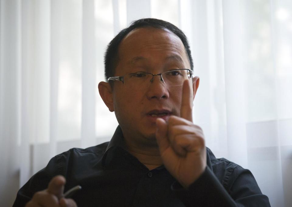 In this Saturday, April 12, 2014 photo, David Tang, a London-based lawyer working with U.K. firm Stewarts Law and an American firm, speaks during an interview at a hotel room in Beijing. Major disasters draw lawyers looking to sign up clients for big lawsuits, and the missing Malaysia Airlines Flight 370 with mostly Chinese passengers aboard has been no exception, with lawyers from various firms descending on a Beijing hotel where relatives have stayed, and even traveling around China to visit them in their homes. Tang was in Beijing this past weekend meeting Chinese relatives at a hotel where they have been staying. when they meet, he shows the relatives an information sheet describing how insurance payments for loss of life differ according to nationality. (AP Photo/Andy Wong)