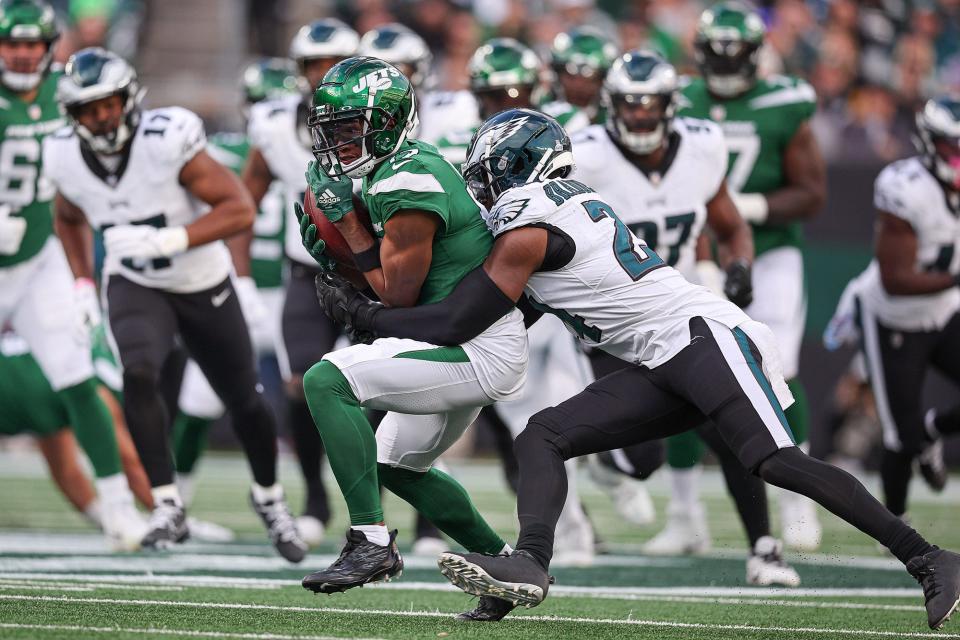 New York Jets wide receiver Garrett Wilson (17) is tackled by Philadelphia Eagles cornerback James Bradberry (24) tackles during the first half at MetLife Stadium on Oct 15, 2023.