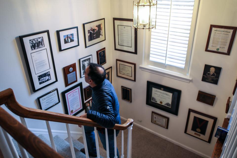 Ed Heil, a family member of Dr. William Anderson, looks over historical photos, awards, and memorabilia on Thursday at  Anderson's home in Bingham Farms.