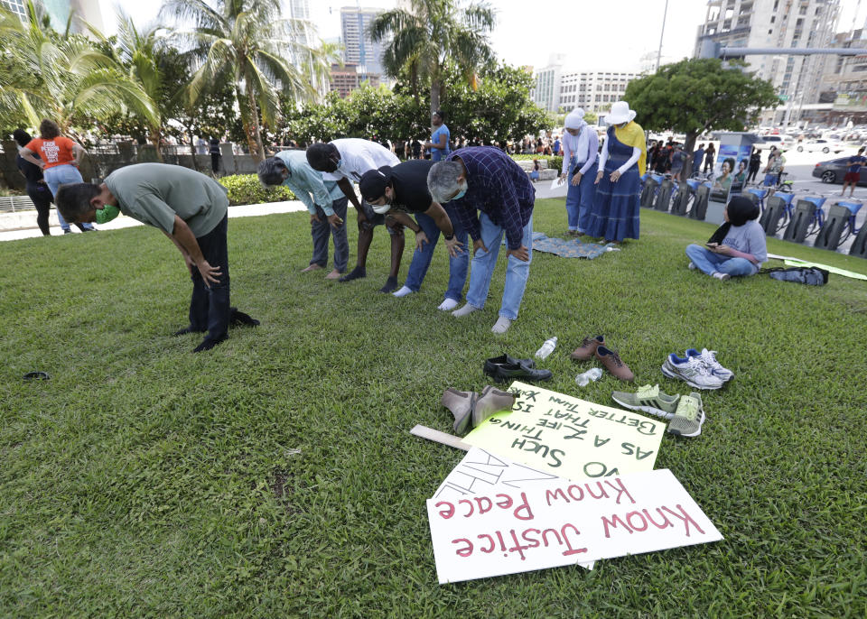 Muslim protesters pray before joining a demonstration in the death of George Lloyd , Sunday, May 31, 2020, in Miami. (AP Photo/Wilfredo Lee)