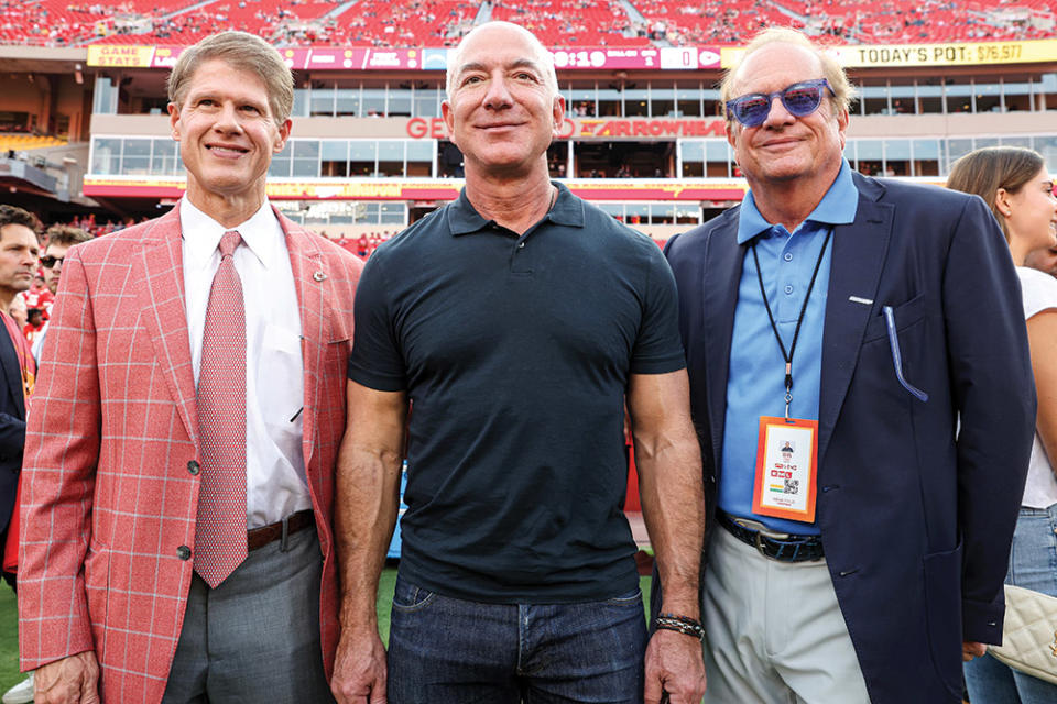 From left: Kansas City Chiefs owner Clark Hunt, Jeff Bezos and Los Angeles Chargers owner Dean Spanos on the field before an NFL game in September 2022.