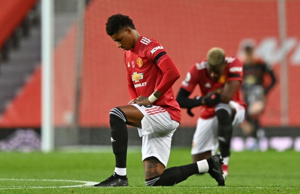 Marcus Rashford and Paul Pogba take a knee.